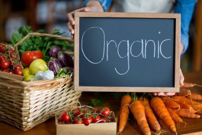 female-staff-holding-organic-sign-board